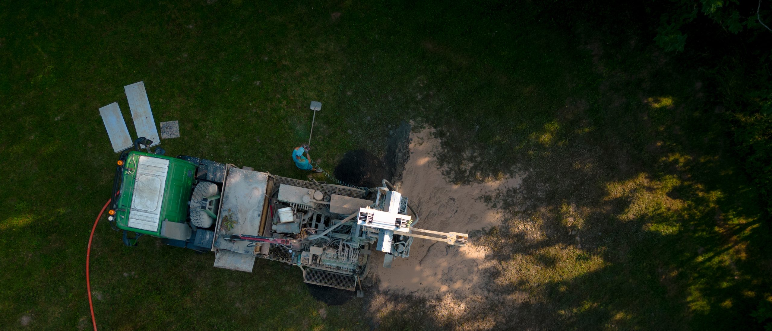 aerial shot of water well drilling rig boring dowin into the earth.